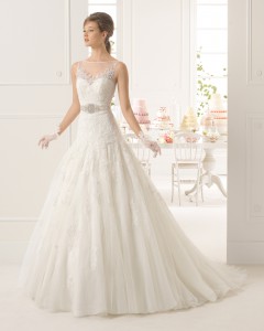 Denne brudekjole er i tyl og blonde med krystalbælte, A-linje samt strutskørt med slæb.